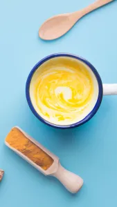 turmeric coconut coffee in the vintage glass with blue background