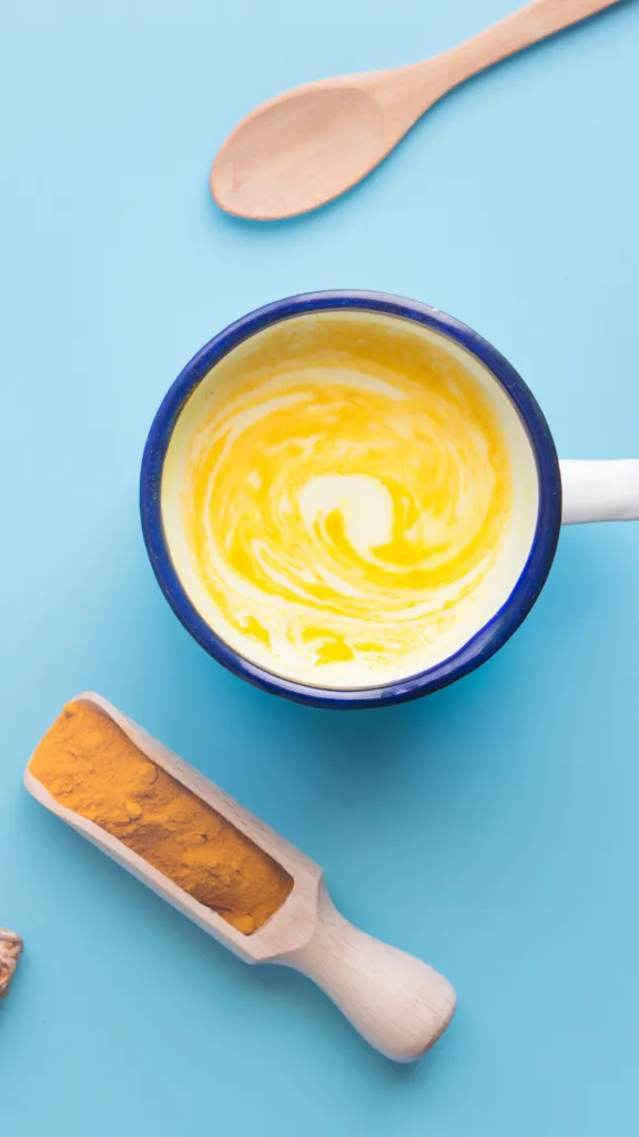 turmeric coconut coffee in the vintage glass with blue background