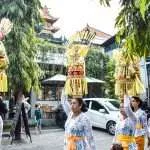 Balinese women bring offering in front of bali direct store pererenan