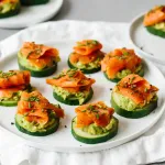smoked salmon avocado cucumber bites on white plate appetizer