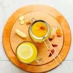 healing turmeric tonic on the wood coster