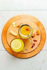 healing turmeric tonic on the wood coster