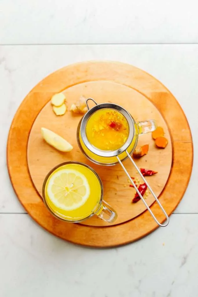 healing turmeric tonic on the wood coster